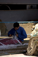 Man fixing fishing nets